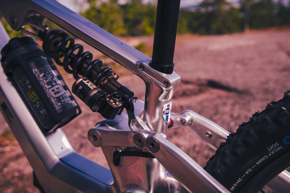Close view of the Hiisi's machined suspension linkage and coil shock